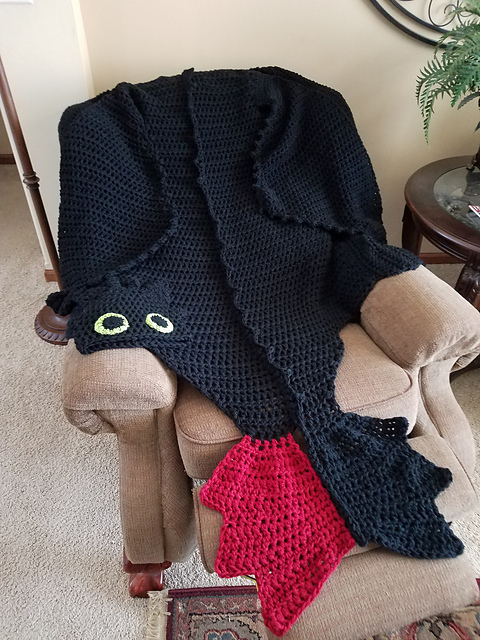 Dragon Blanket crochet pattern set which includes a wearable dragon cape blanket and a matching dragon cap