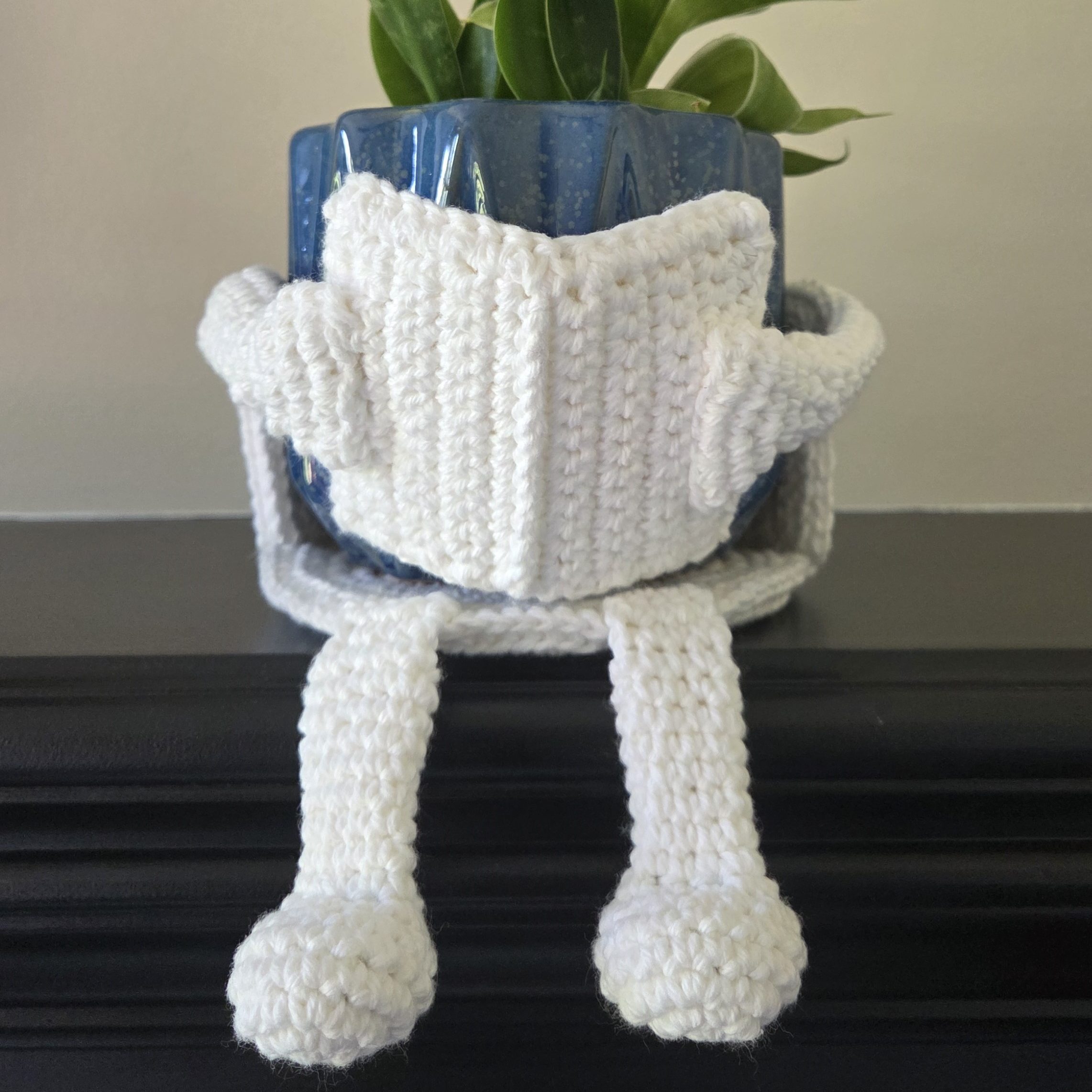 Book Reader crochet plant pot holder free pattern - Crochet plant pot cover with a book, arms, and legs
